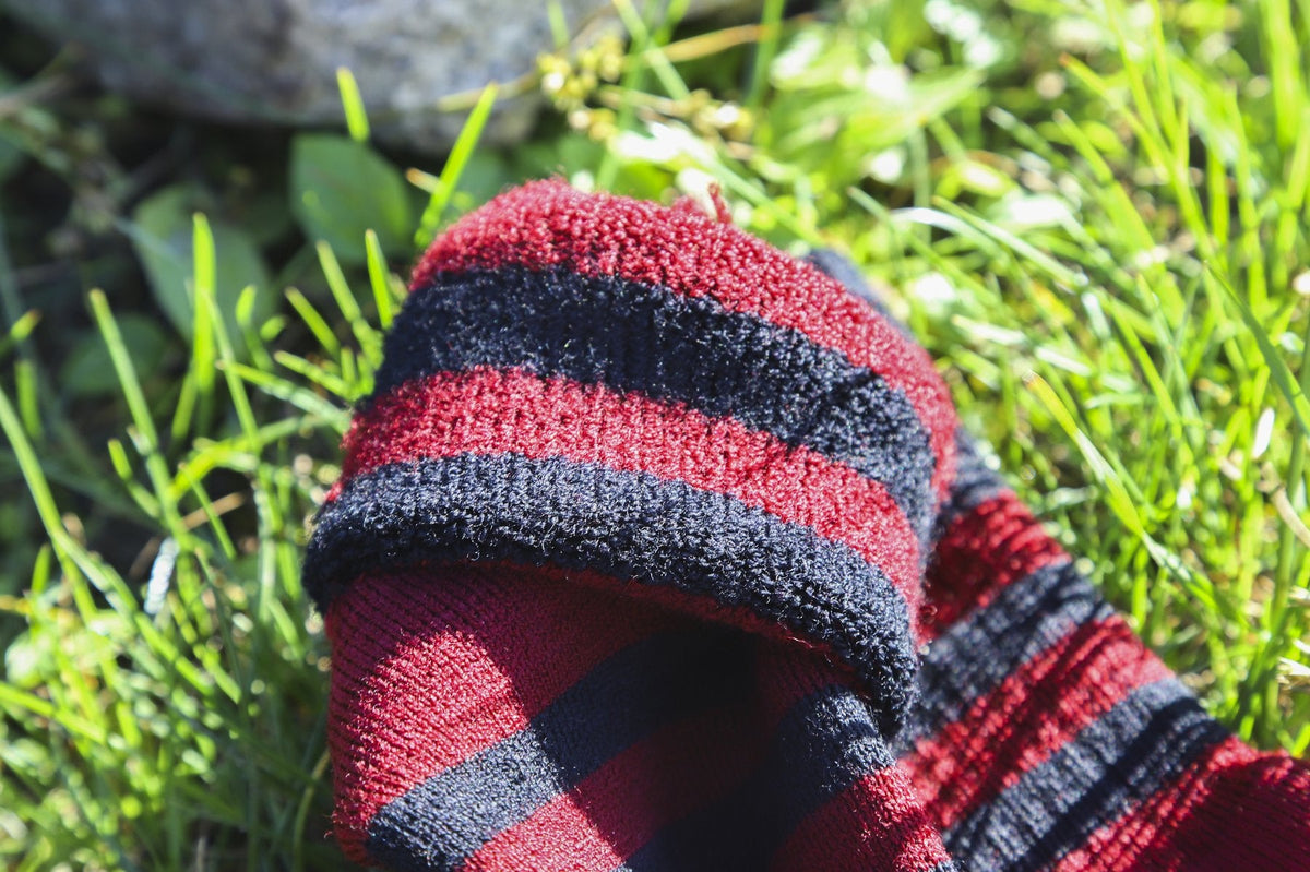 Merino wool sock turned inside out on grass, showing the looped inner face that sits against skin