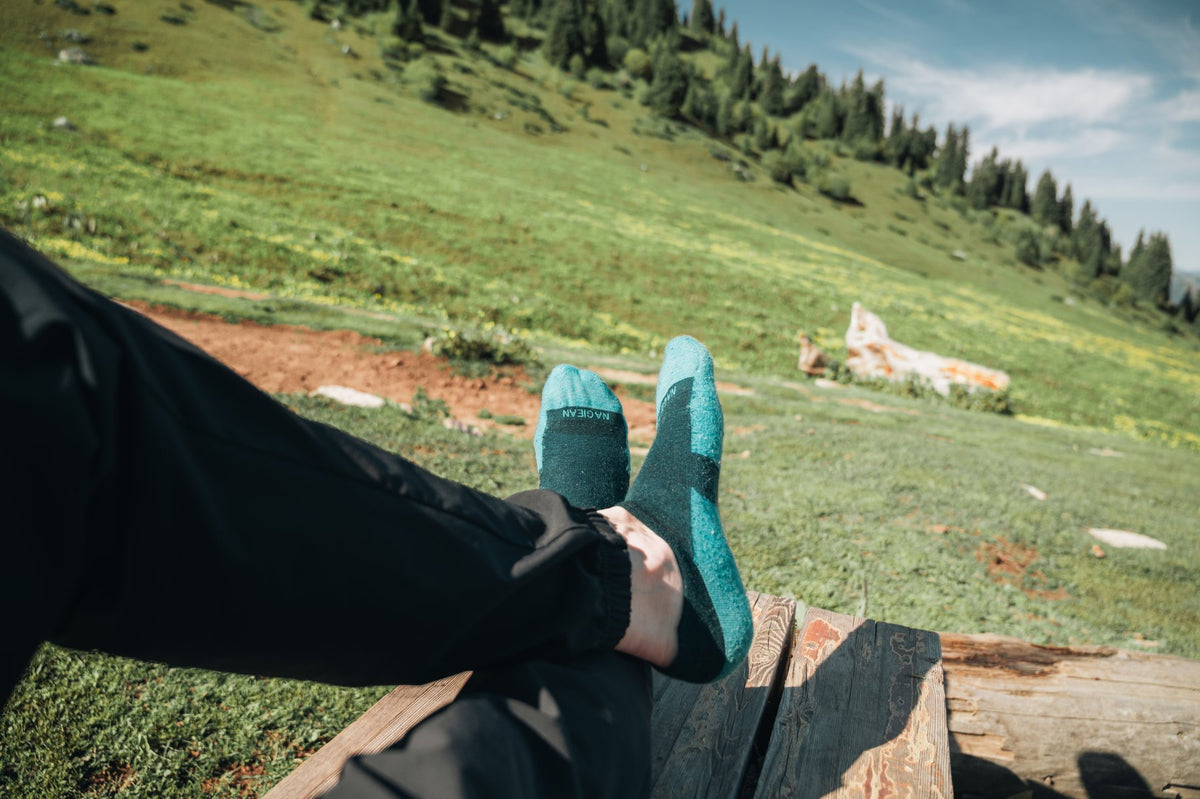 Resting in lightweight merino wool socks on an alpine meadow